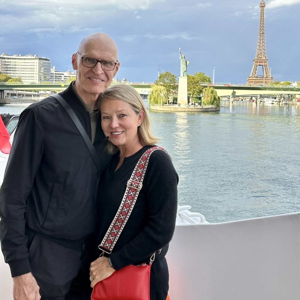 Julie, female founder of Ethos Luxury Advisors posing in front of the Eiffel tour on an excursion from the joie de vivre seine river cruise