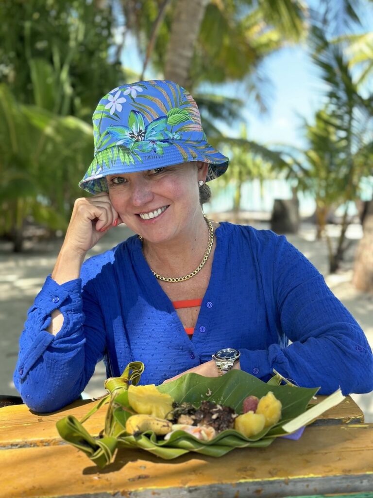 Julie, founder of Ethos Luxury Advisors enjoying a Picnic on a Motu an excursion while sailing on MS Paul Gauguin