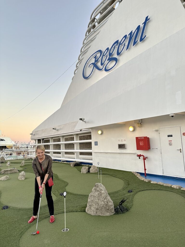 Julie, founder of Ethos Luxury Travel, golfing on board the seven seas mariner, all inclusive cruise