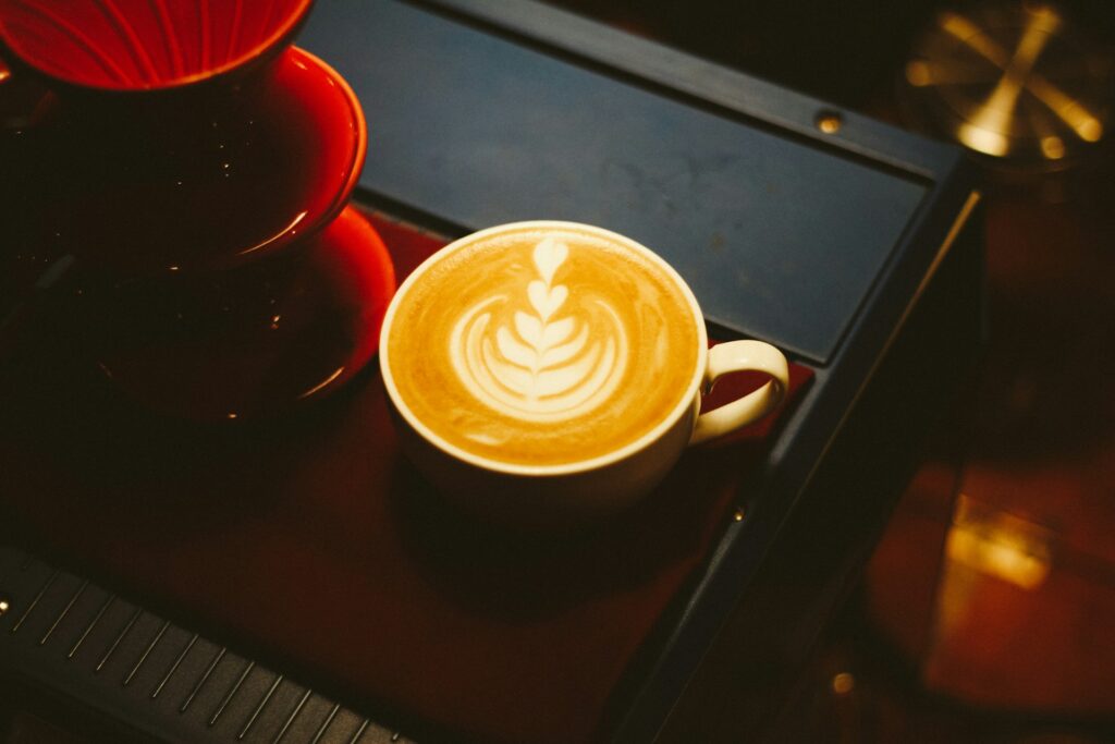 latte in a brown ceramic mug at a cafe