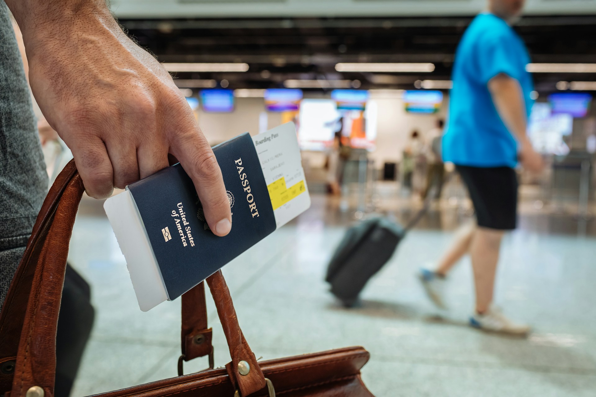 person holding us passport with boarding pass poking out.