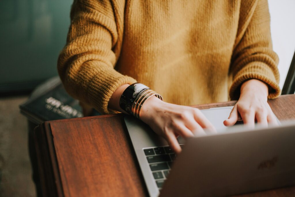 person searching for vacation planners for group travel planning on laptop