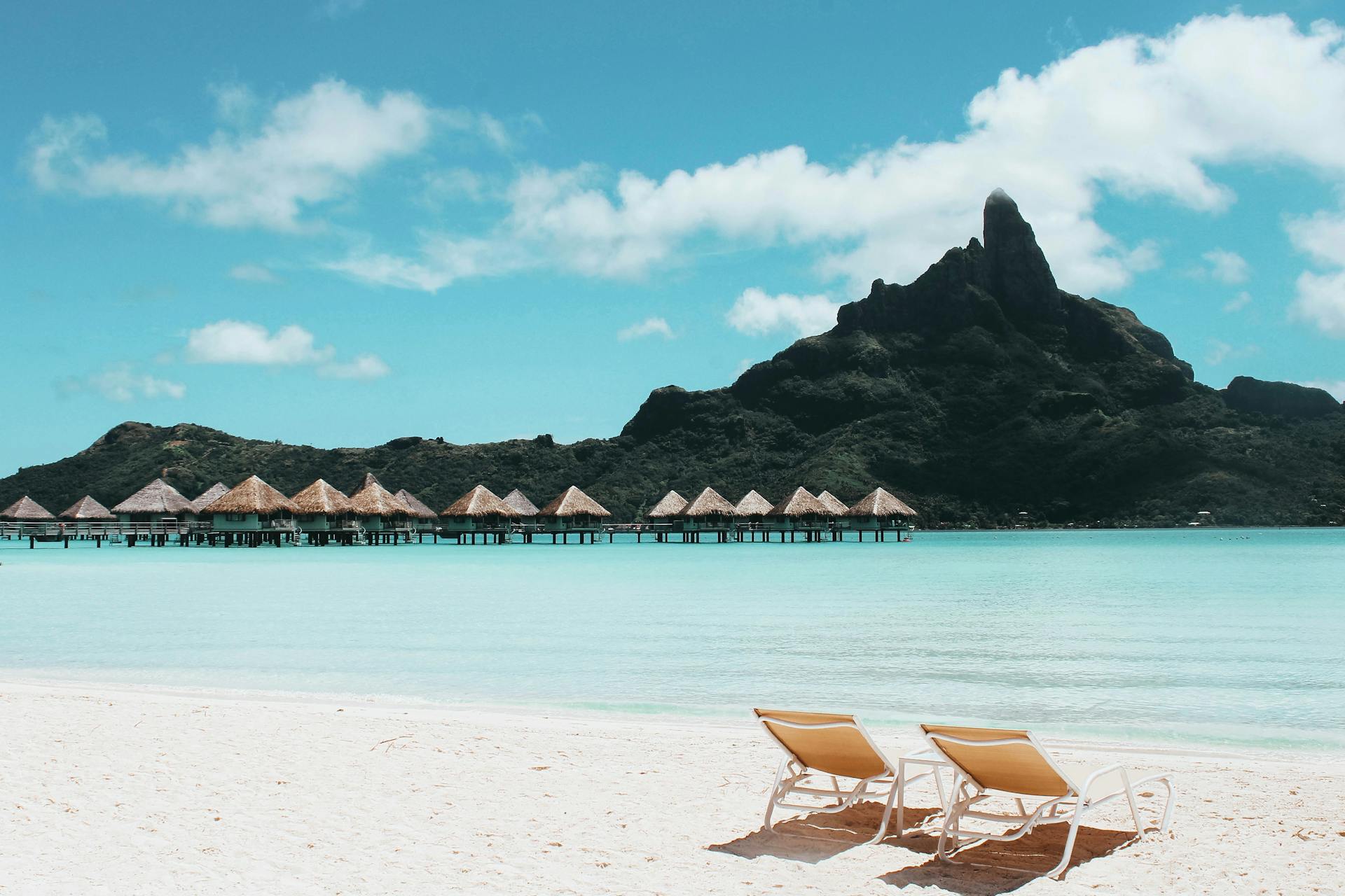 An Island with Cottages and Beach Chairs in bora bora french polynesia