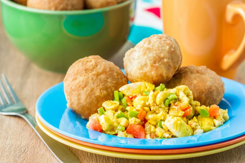 Jamaican ackee and saltfish served with a side of fried dumplings