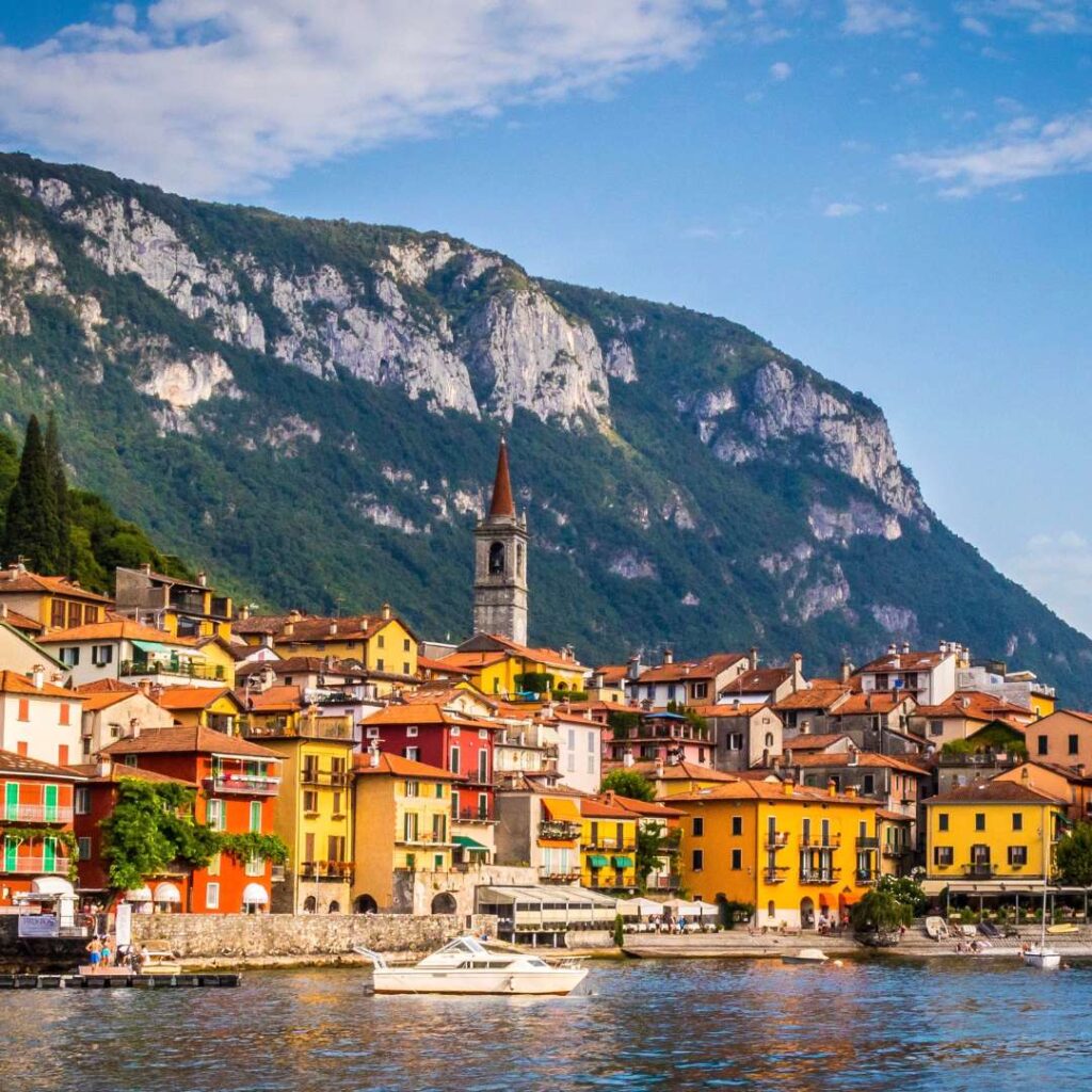 colorful homes in front of a mountain in Lake Como