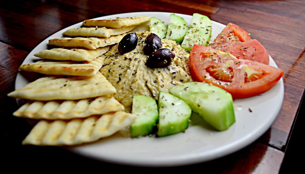 Sliced Tomato With Cucumber, Hummus, and Pita