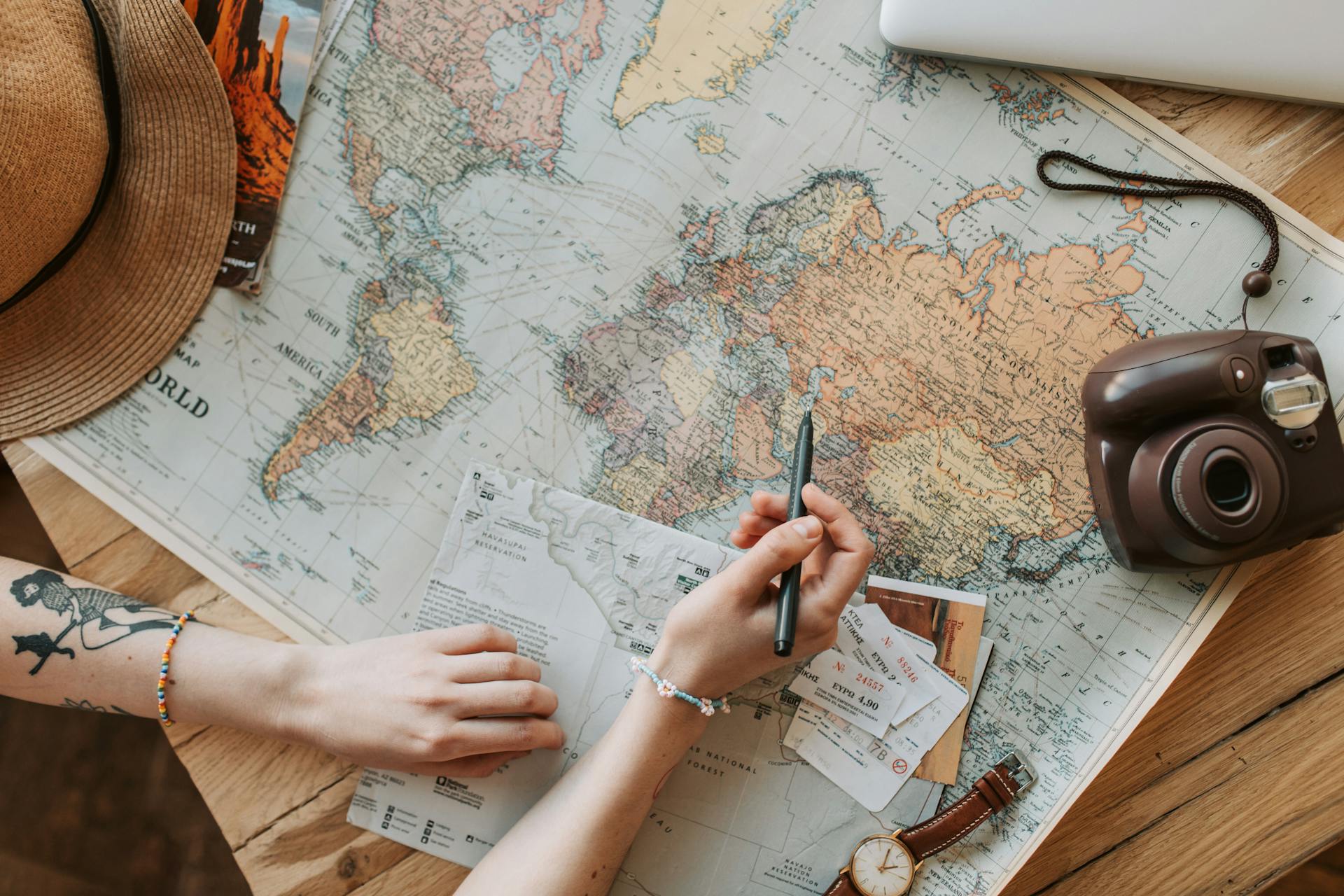 Woman Looking at a Map with a Pen in Her Hand