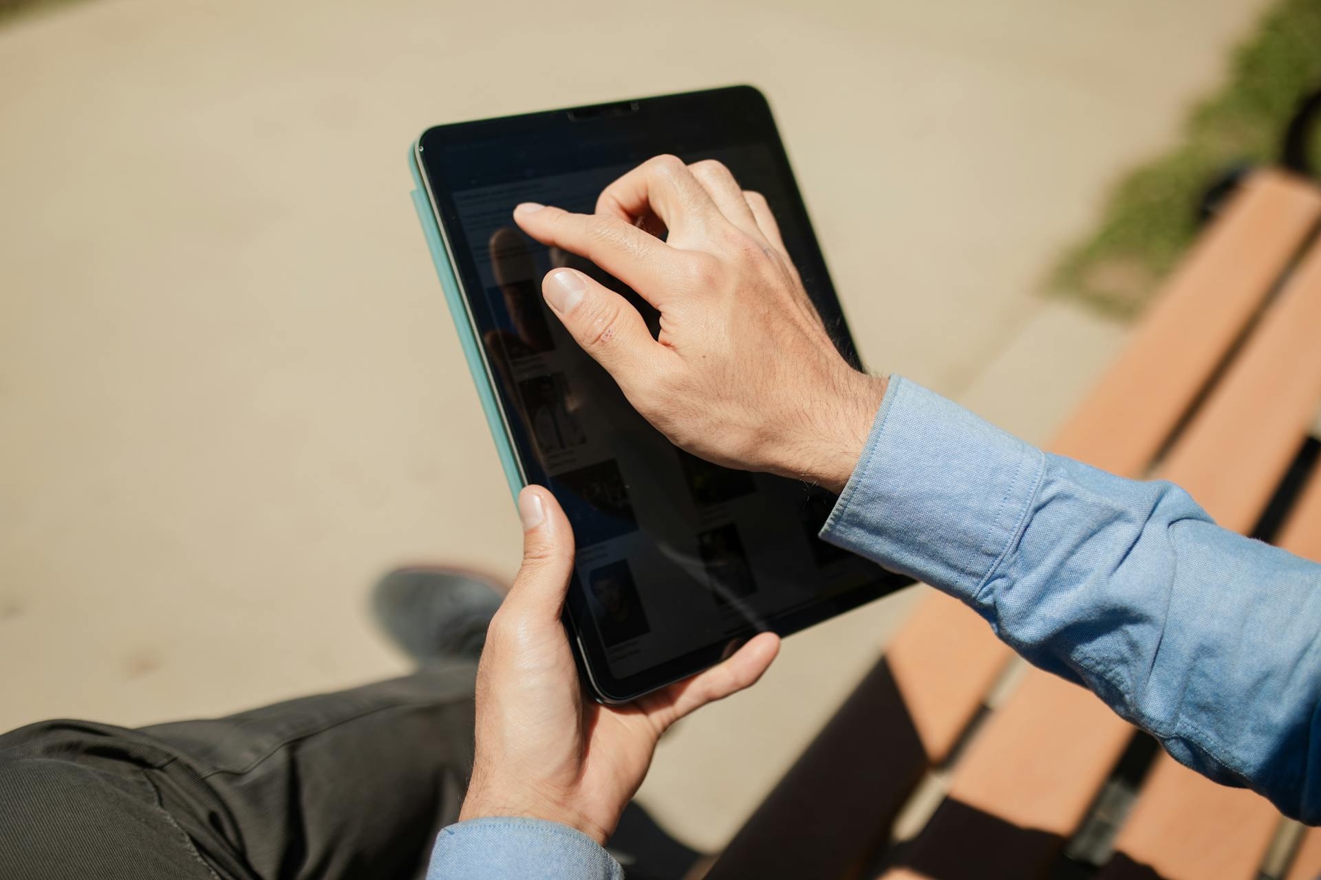 a person using a tablet with the brightness turned down