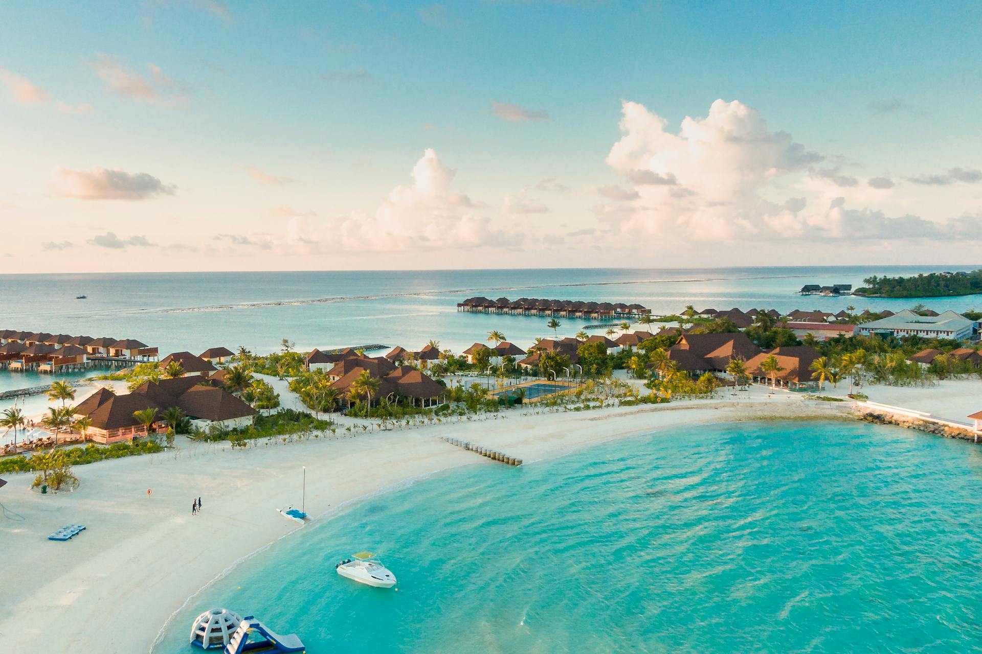 aerial view of an island resort with a beautiful beach in the maldives