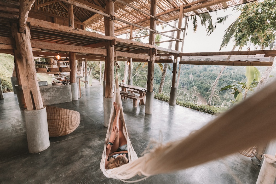 white cloth hammock in an interior-exterior space in the woods