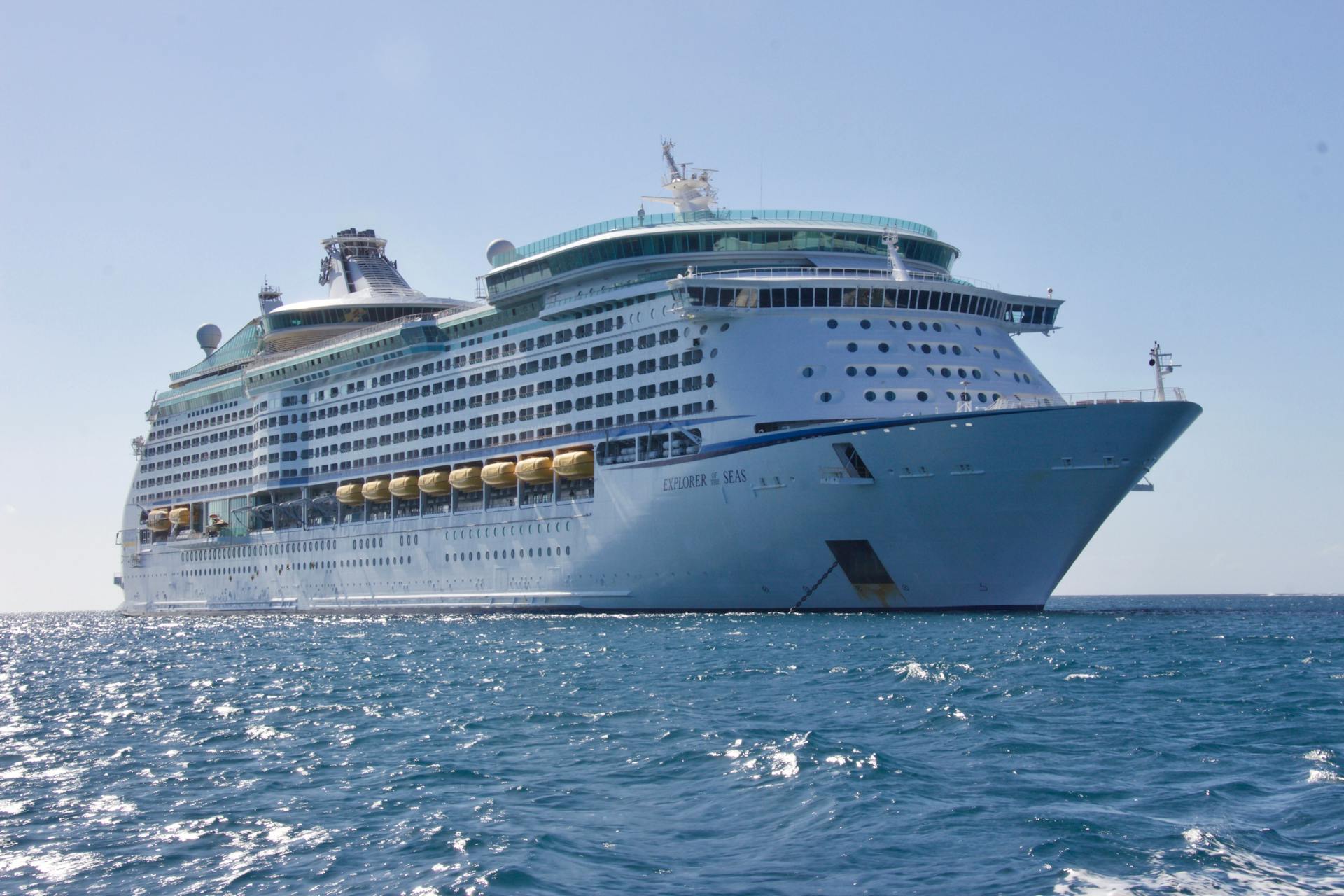 white ocean cruise ship sailing in open waters