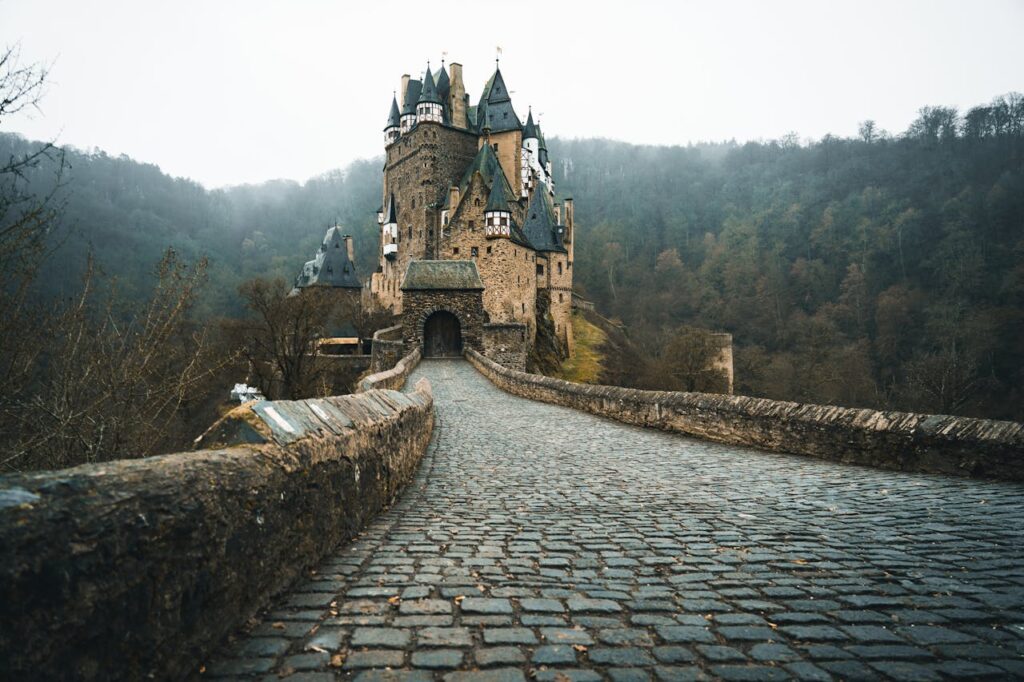 stone walkway leading to a stone castle in germany